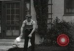 Image of man performs stunts on 9 months baby Los Angeles California USA, 1931, second 59 stock footage video 65675023610