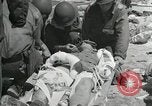 Image of medics aid wounded Marines at Tarawa Tarawa Gilbert Islands, 1943, second 4 stock footage video 65675023680