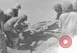 Image of medics aid wounded Marines at Tarawa Tarawa Gilbert Islands, 1943, second 47 stock footage video 65675023680