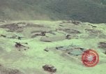 Image of 155mm howitzer slung beneath a CH-54 helicopter Vietnam, 1969, second 3 stock footage video 65675023785