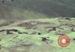 Image of 155mm howitzer slung beneath a CH-54 helicopter Vietnam, 1969, second 6 stock footage video 65675023785