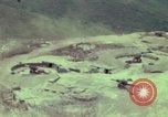 Image of 155mm howitzer slung beneath a CH-54 helicopter Vietnam, 1969, second 7 stock footage video 65675023785