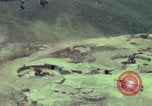 Image of 155mm howitzer slung beneath a CH-54 helicopter Vietnam, 1969, second 8 stock footage video 65675023785