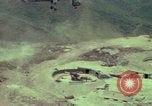 Image of 155mm howitzer slung beneath a CH-54 helicopter Vietnam, 1969, second 10 stock footage video 65675023785