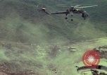 Image of 155mm howitzer slung beneath a CH-54 helicopter Vietnam, 1969, second 13 stock footage video 65675023785