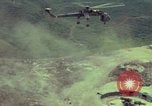 Image of 155mm howitzer slung beneath a CH-54 helicopter Vietnam, 1969, second 14 stock footage video 65675023785
