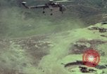 Image of 155mm howitzer slung beneath a CH-54 helicopter Vietnam, 1969, second 15 stock footage video 65675023785