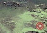 Image of 155mm howitzer slung beneath a CH-54 helicopter Vietnam, 1969, second 17 stock footage video 65675023785