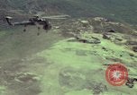 Image of 155mm howitzer slung beneath a CH-54 helicopter Vietnam, 1969, second 18 stock footage video 65675023785
