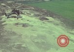Image of 155mm howitzer slung beneath a CH-54 helicopter Vietnam, 1969, second 22 stock footage video 65675023785