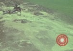 Image of 155mm howitzer slung beneath a CH-54 helicopter Vietnam, 1969, second 23 stock footage video 65675023785