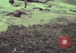 Image of 155mm howitzer slung beneath a CH-54 helicopter Vietnam, 1969, second 26 stock footage video 65675023785