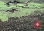 Image of 155mm howitzer slung beneath a CH-54 helicopter Vietnam, 1969, second 27 stock footage video 65675023785
