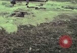 Image of 155mm howitzer slung beneath a CH-54 helicopter Vietnam, 1969, second 28 stock footage video 65675023785