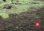 Image of 155mm howitzer slung beneath a CH-54 helicopter Vietnam, 1969, second 29 stock footage video 65675023785