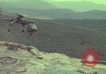 Image of 155mm howitzer slung beneath a CH-54 helicopter Vietnam, 1969, second 34 stock footage video 65675023785