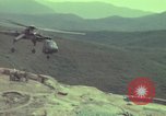 Image of 155mm howitzer slung beneath a CH-54 helicopter Vietnam, 1969, second 35 stock footage video 65675023785