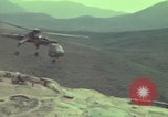 Image of 155mm howitzer slung beneath a CH-54 helicopter Vietnam, 1969, second 36 stock footage video 65675023785