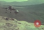 Image of 155mm howitzer slung beneath a CH-54 helicopter Vietnam, 1969, second 37 stock footage video 65675023785