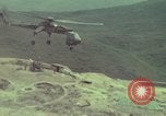 Image of 155mm howitzer slung beneath a CH-54 helicopter Vietnam, 1969, second 38 stock footage video 65675023785