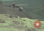 Image of 155mm howitzer slung beneath a CH-54 helicopter Vietnam, 1969, second 39 stock footage video 65675023785