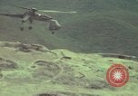 Image of 155mm howitzer slung beneath a CH-54 helicopter Vietnam, 1969, second 41 stock footage video 65675023785