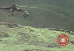 Image of 155mm howitzer slung beneath a CH-54 helicopter Vietnam, 1969, second 42 stock footage video 65675023785
