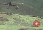 Image of 155mm howitzer slung beneath a CH-54 helicopter Vietnam, 1969, second 43 stock footage video 65675023785