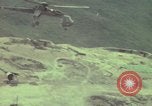 Image of 155mm howitzer slung beneath a CH-54 helicopter Vietnam, 1969, second 44 stock footage video 65675023785