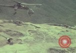Image of 155mm howitzer slung beneath a CH-54 helicopter Vietnam, 1969, second 45 stock footage video 65675023785