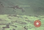 Image of 155mm howitzer slung beneath a CH-54 helicopter Vietnam, 1969, second 49 stock footage video 65675023785