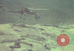 Image of 155mm howitzer slung beneath a CH-54 helicopter Vietnam, 1969, second 50 stock footage video 65675023785