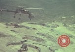 Image of 155mm howitzer slung beneath a CH-54 helicopter Vietnam, 1969, second 52 stock footage video 65675023785