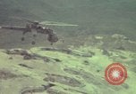 Image of 155mm howitzer slung beneath a CH-54 helicopter Vietnam, 1969, second 53 stock footage video 65675023785