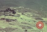 Image of 155mm howitzer slung beneath a CH-54 helicopter Vietnam, 1969, second 56 stock footage video 65675023785