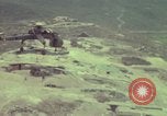 Image of 155mm howitzer slung beneath a CH-54 helicopter Vietnam, 1969, second 57 stock footage video 65675023785