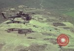 Image of 155mm howitzer slung beneath a CH-54 helicopter Vietnam, 1969, second 58 stock footage video 65675023785