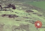 Image of 155mm howitzer slung beneath a CH-54 helicopter Vietnam, 1969, second 59 stock footage video 65675023785