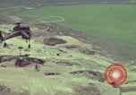 Image of 155mm howitzer slung beneath a CH-54 helicopter Vietnam, 1969, second 61 stock footage video 65675023785