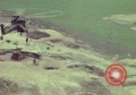 Image of 155mm howitzer slung beneath a CH-54 helicopter Vietnam, 1969, second 62 stock footage video 65675023785