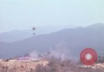 Image of CH-54 delivers a howitzer to Fire Support Base Whip Vietnam, 1969, second 10 stock footage video 65675023786