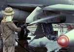 Image of Vietnamese contractor personnel clean F-100D airplane Vietnam, 1966, second 15 stock footage video 65675024991