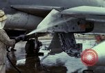 Image of Vietnamese contractor personnel clean F-100D airplane Vietnam, 1966, second 19 stock footage video 65675024991