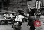 Image of Children Play and Adults Work in rice Fields During Spring Time Japan, 1934, second 51 stock footage video 65675025118