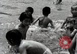 Image of Children Play and Adults Work in rice Fields During Spring Time Japan, 1934, second 60 stock footage video 65675025118