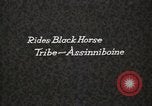 Image of Native American Indian Assinniboine Chief Rides Black Horse Fort Browning Montana USA, 1930, second 1 stock footage video 65675025306