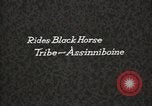 Image of Native American Indian Assinniboine Chief Rides Black Horse Fort Browning Montana USA, 1930, second 5 stock footage video 65675025306
