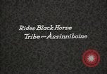Image of Native American Indian Assinniboine Chief Rides Black Horse Fort Browning Montana USA, 1930, second 6 stock footage video 65675025306
