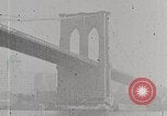 Image of New York Harbor and Brooklyn Bridge seen from steamship New York City USA, 1917, second 25 stock footage video 65675025400