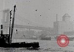 Image of New York Harbor and Brooklyn Bridge seen from steamship New York City USA, 1917, second 33 stock footage video 65675025400
